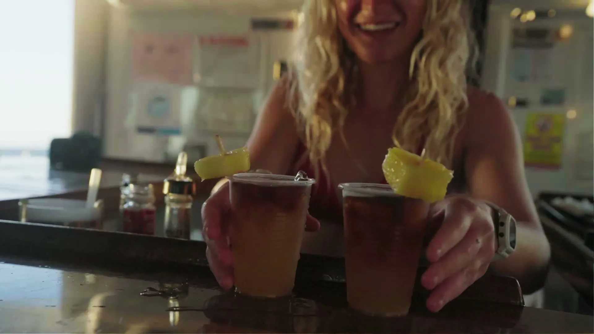 Two mai tais with pineapple garnish at the bar