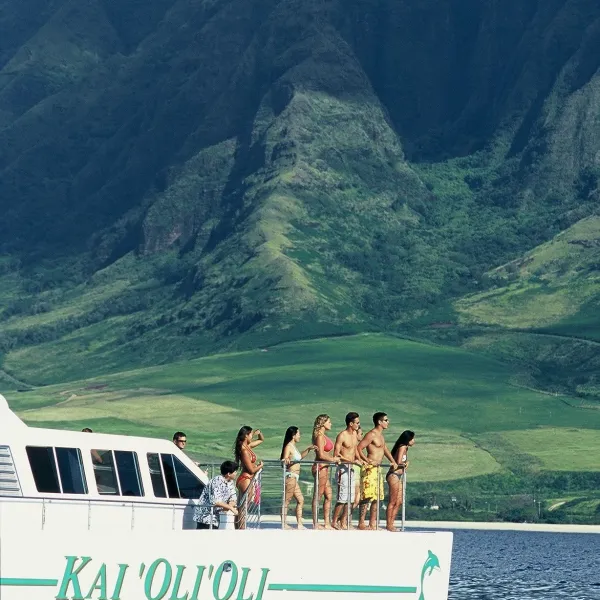 a small boat in a body of water with a mountain in the background
